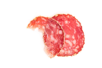 Slice of salami sausage on a white background