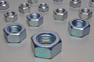 Steel nuts on metal surface