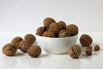 Walnuts in a white bowl. Kitchen decoration.