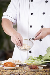 Chef holding the noodle to colander before cooking