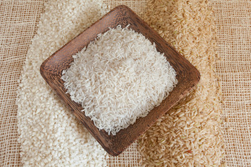 Uncooked Minerbe, Ribe and Basmati rice in a wooden cup