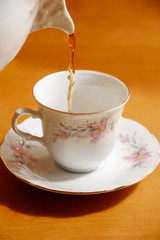 pouring tea to a teacup