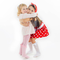 sisters hugging isolated on white background