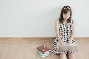Asian woman using laptop at home