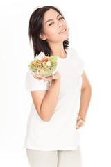 Pretty girl eating fresh vegetable salad