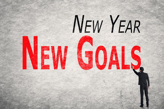 write words on wall, New Year New Goals
