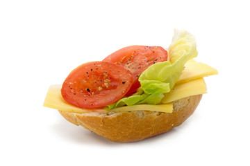 bread roll with cheese, salad and tomatoes isolated on a white