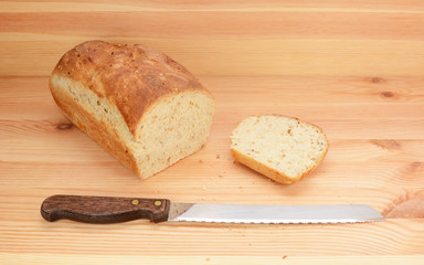 Bread knife with freshly sliced loaf of bread