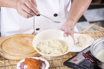 Chef cooking Noodle with vegetable oil