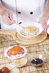 Chef scoop crispy garlic for cooking Noodle