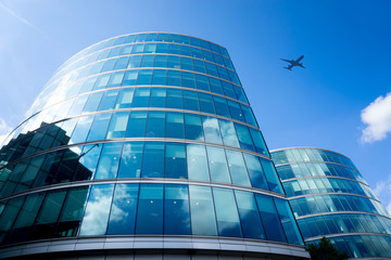 Fototapeta na wymiar A jet airplane business office towers building, London