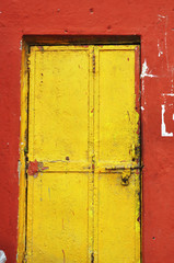 Vintage front door and red wall in India