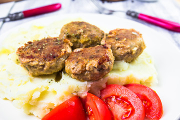 Fried pork chops boiled potatoes tomatoes