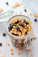 fruits black and white currants jar wooden table