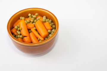 Bowl of boiled carrots and green peas