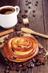 Sweet bun with raisins and coffee