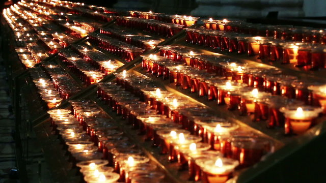 Burning candles in a church N8