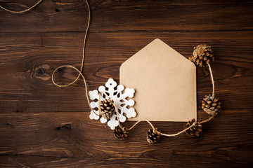 Envelope with Christmas decoration on wood table