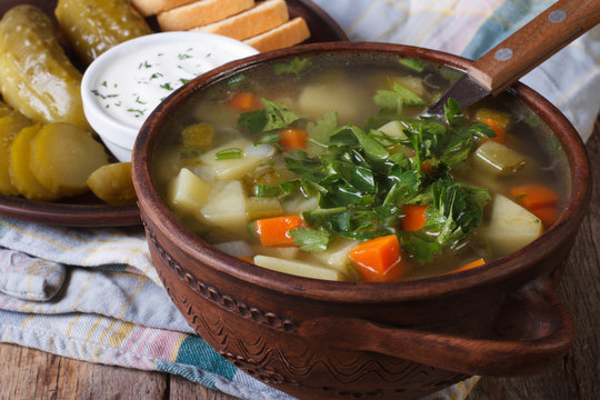 Polish cucumber soup in a brown bowl close-up