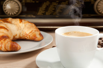 Radiohören beim Frühstückskaffee mit Croissant