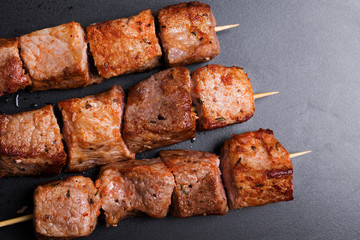 Pork kebabs on wooden skewers