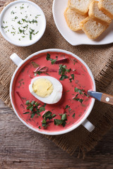 Beetroot soup with egg close up. vertical top view