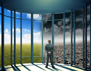 Fototapeta premium Businessman in the office with glass walls
