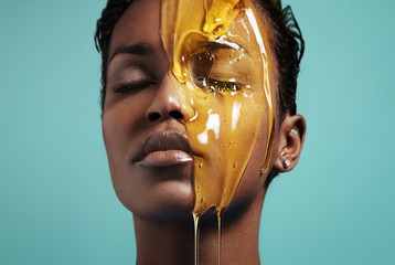 closeup portrait of a black woman with a honey on her face - 75858108