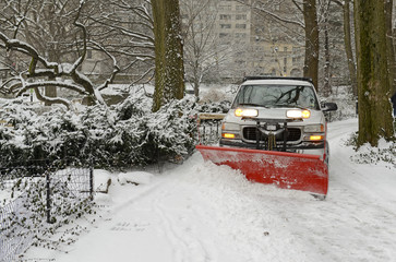 Fototapeta premium Truck plowing snowy road after snowstorm