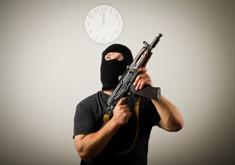 Fototapeta na wymiar Man with gun and clock.