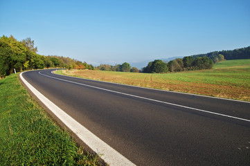 Empty asphalt road in countryside, bend of road