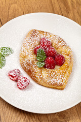 Raspberry pastries with powdered sugar. Selective focus.