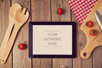 Tablet mock up template with cooking utensil. View from above
