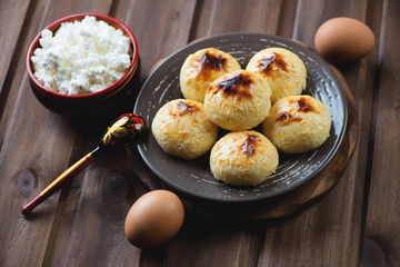 Curd pancakes over rustic wooden background, studio shot