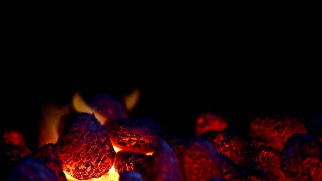 closeup of glowing coal with some flames
