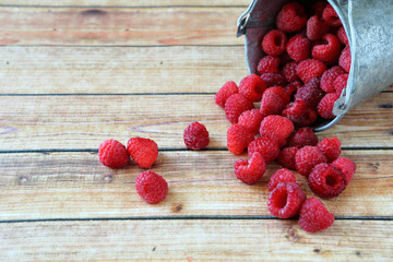 Delicious raspberries in a small bucket