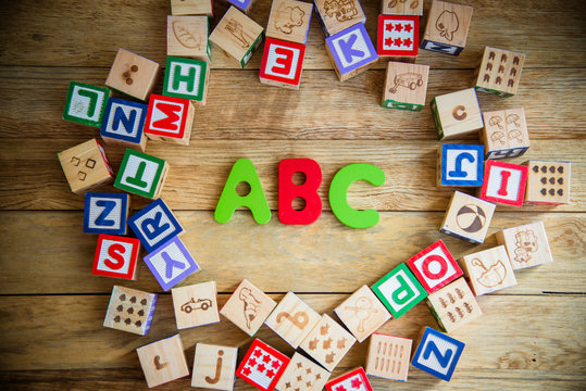 ABC word in wooden block alphabet lay on wooden floor in circle