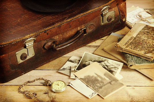 old suitcase, books, photos in retro style