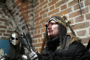 Naklejka premium Person posing with ancient weapons