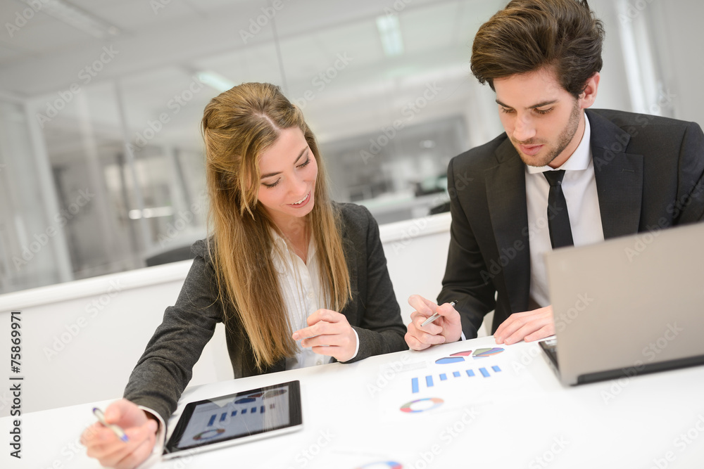 Wall mural business people working around table in modern office