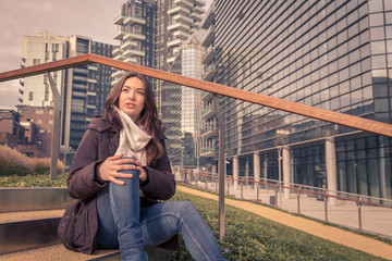 Young beautiful girl posing in the city streets