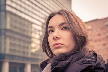 Young beautiful girl posing in the city streets