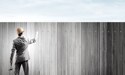 Businessman and banner on wall