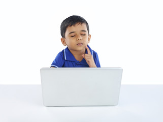 Indian Little Boy Thinking with Laptop