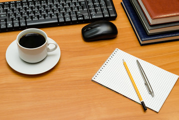 keyboard, cup of coffee and office supplies