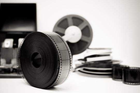 Vintage movie editing desktop in black and white with 35mm reel