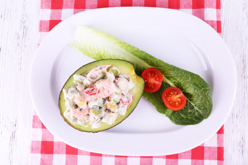 Tasty salad in avocado on plate table close-up