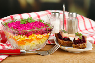 Russian herring salad in glass bowl