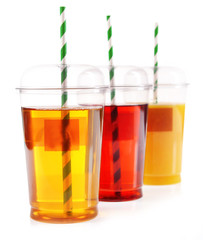 Fruit juices in fast food closed cup with tube and slices