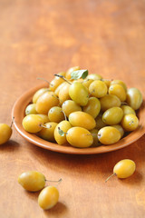 Yellow Plums on a brown plate